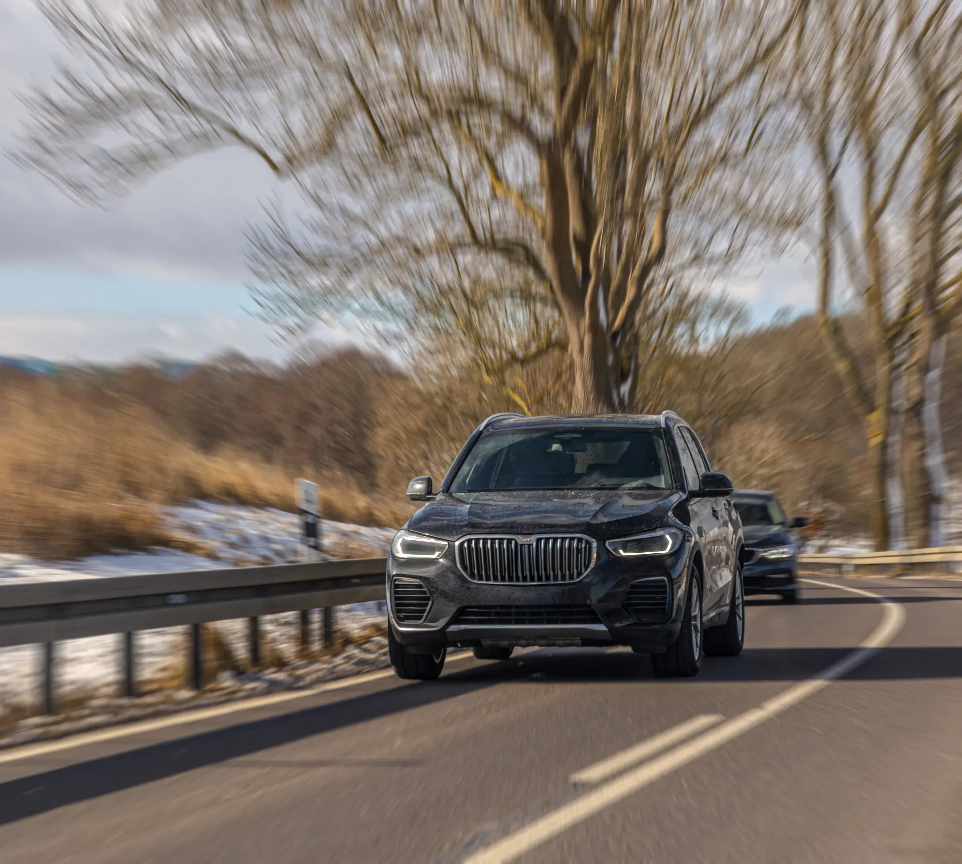 black-modern-suv-driving-winter-highway-dynamic-snowy-road-travel